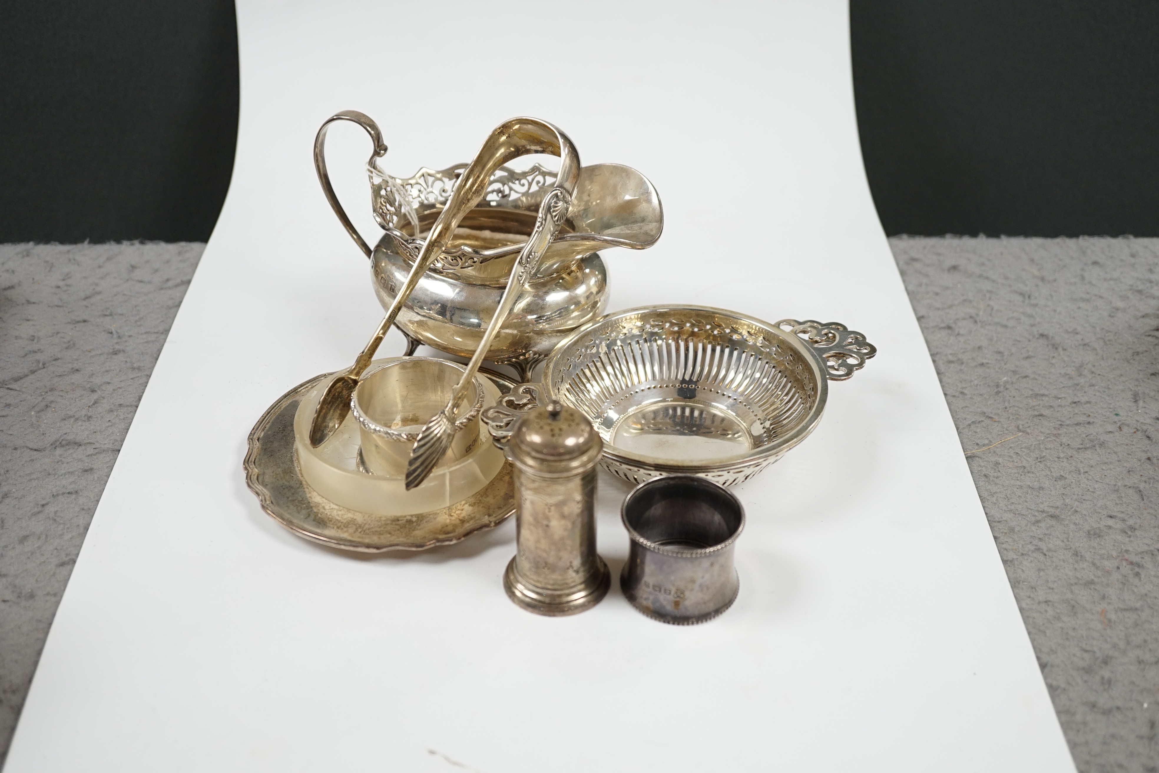Sundry small silver including a pair of Art Devo five bar toast racks by Mappin & Webb, 10.5cm over handles, a Victorian five bar toast rack, a pair of mounted glass butter dishes, cream jug, pair of pierced dishes, cond